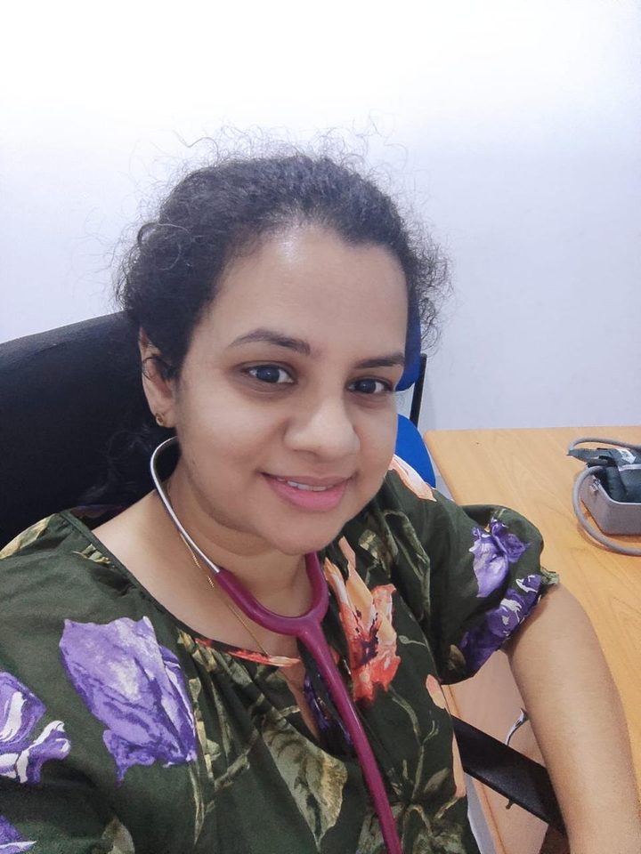Dr. Ashara in her clinic room with a stethoscope around her neck
