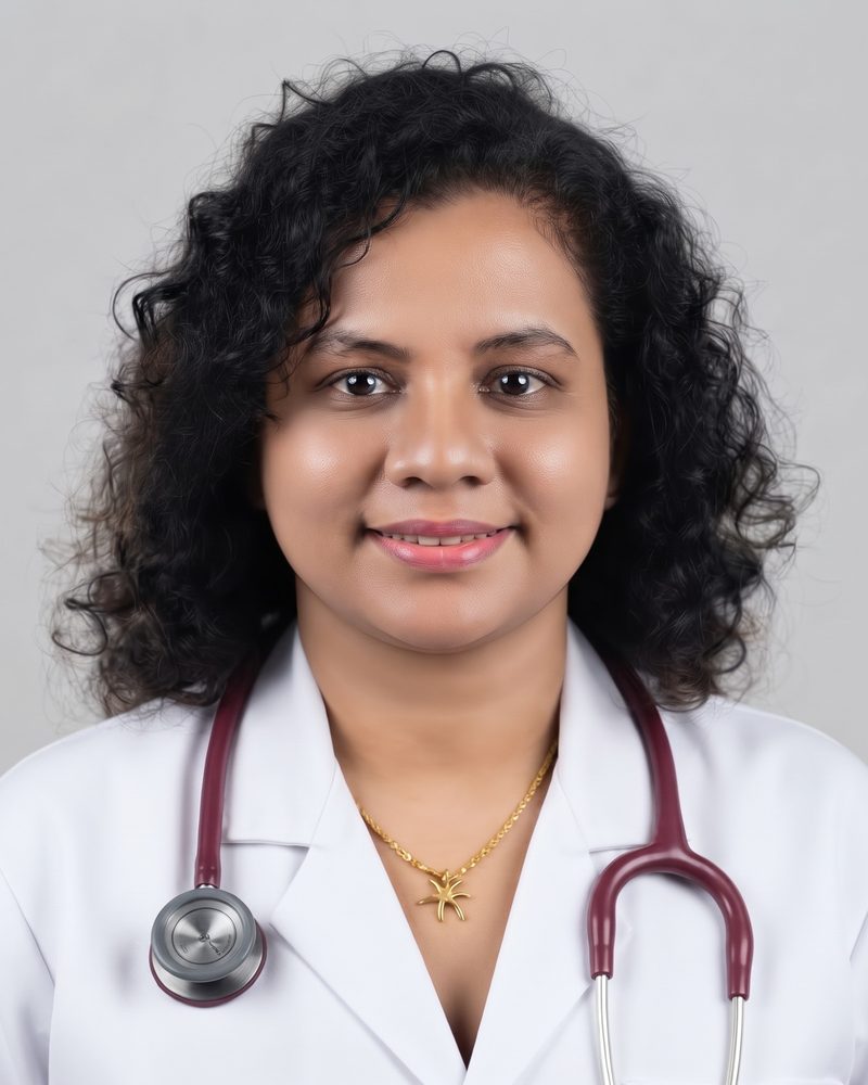 Dr. Ashara Hettiarachchi smiling, wearing a white coat and a stethoscope